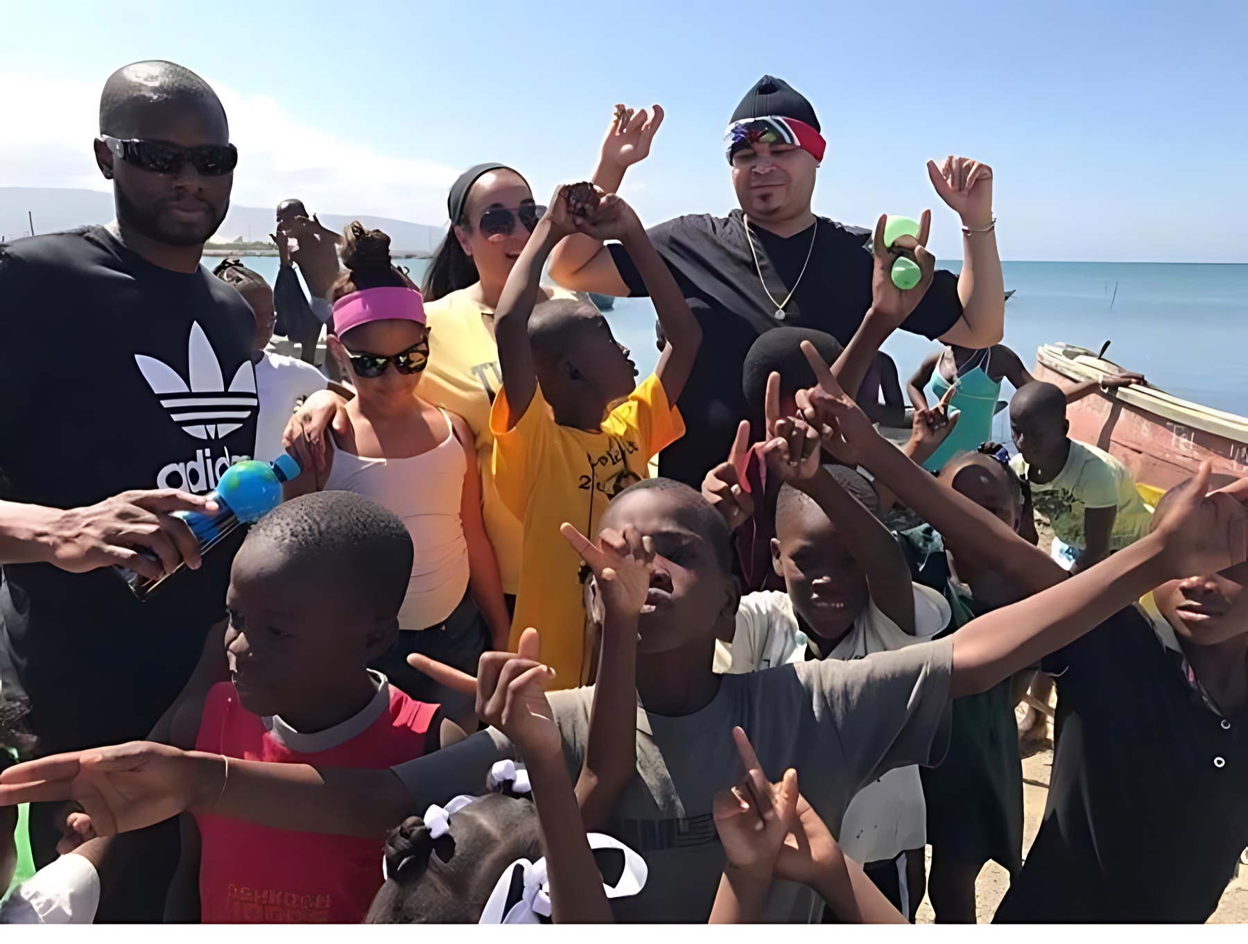 Randa Quraan and volunteers spending time with children during a community mission in Haiti