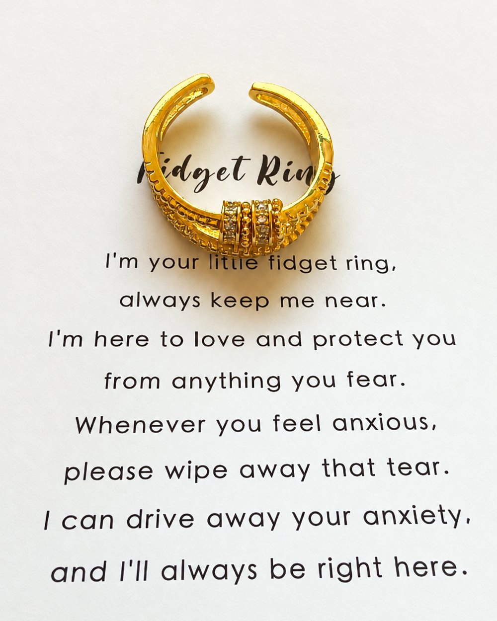 Gold fidget ring on its printed card