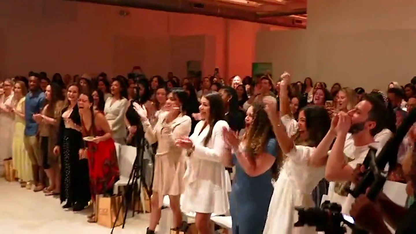 Guests on their feet at a Socially Loud activation