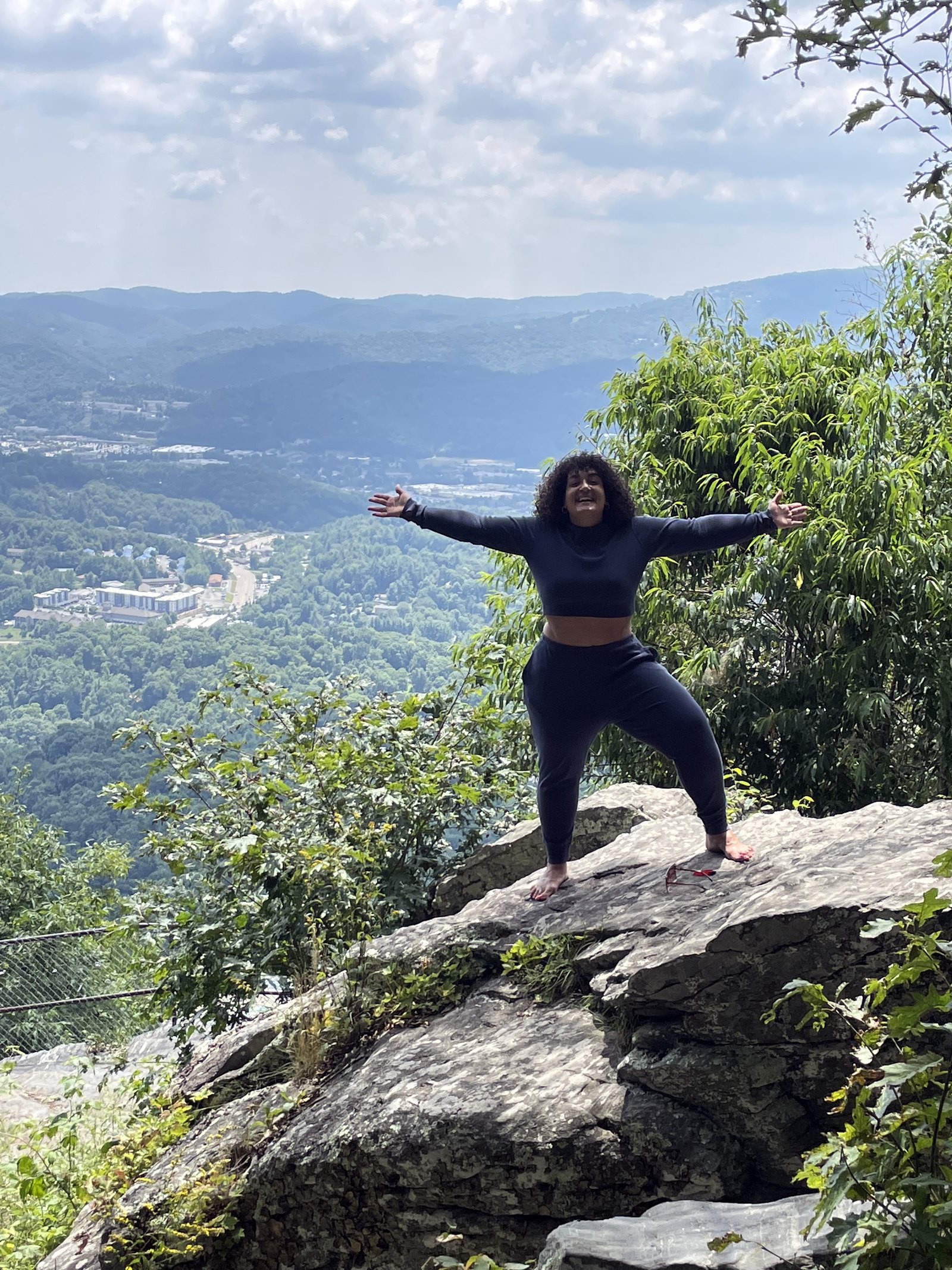 Randa Quraan on a rock overlook in the Blue Ridge Mountains near Boone