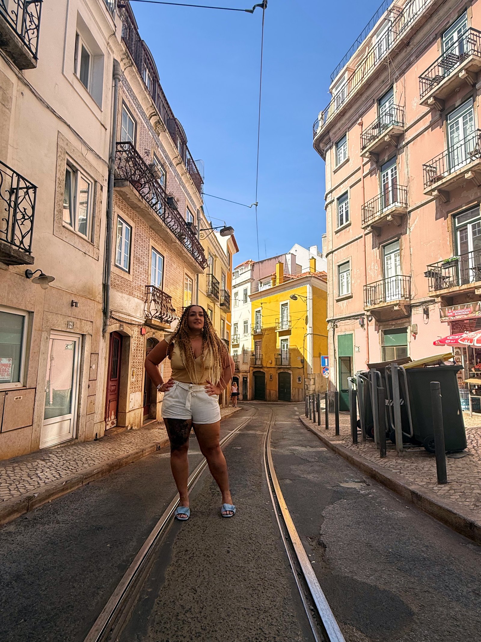 Randa Quraan walking along the tram tracks in Lisbon