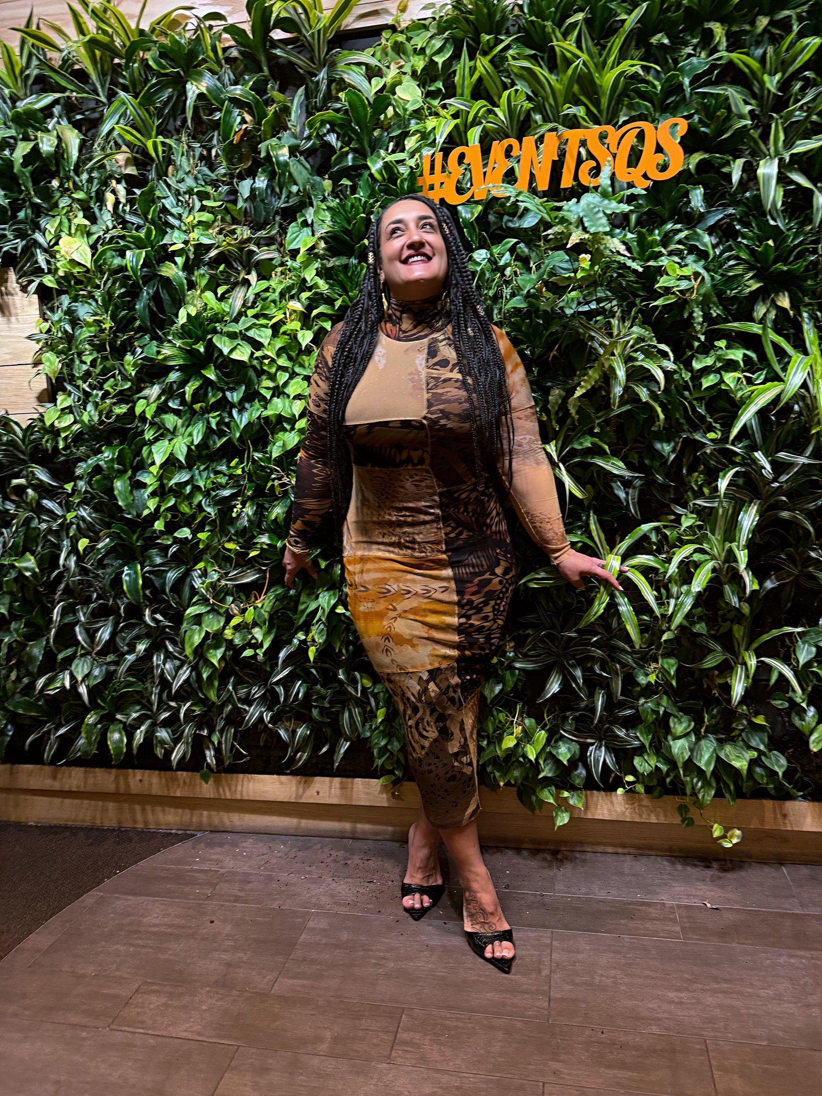 Randa Quraan in front of a living wall at an event in New York