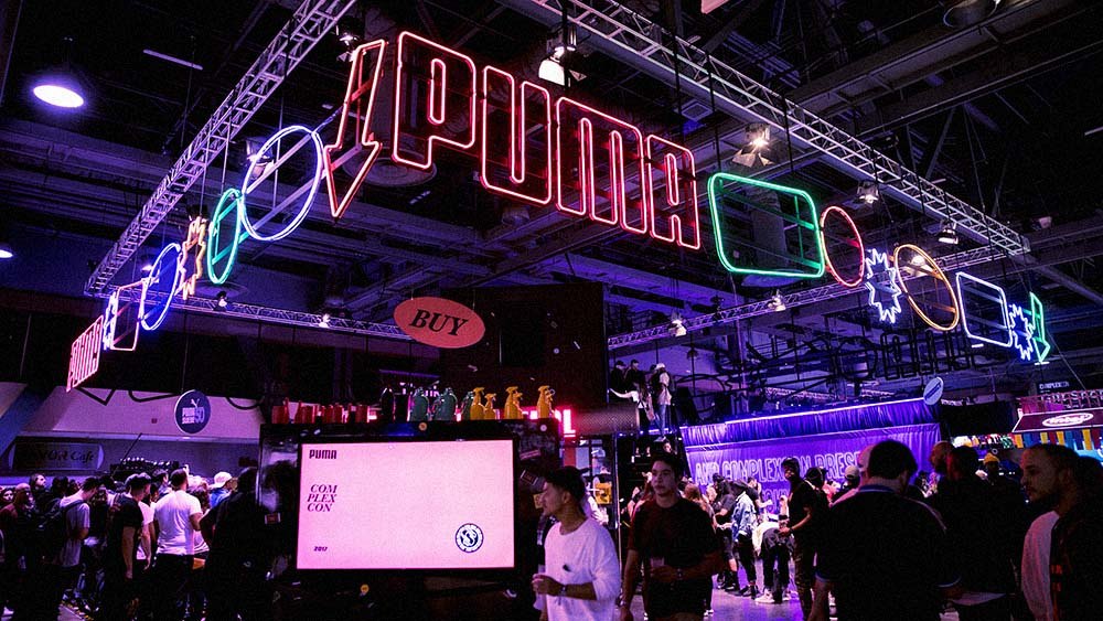 PUMA neon signage over the convention floor