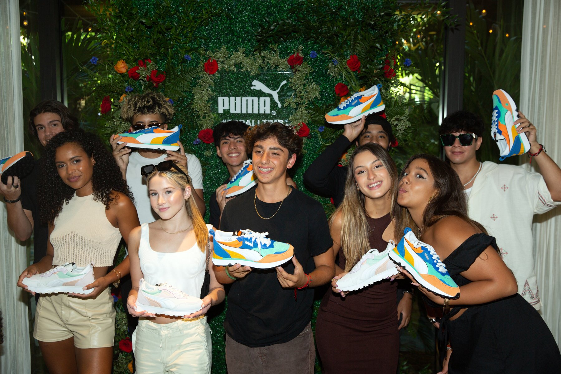 Creators holding the PUMA Rider FV in front of the PUMA wall at Rolling Loud Miami